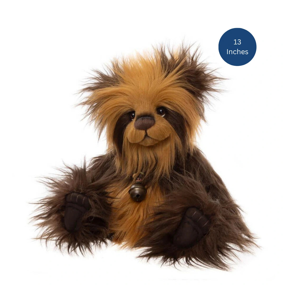 A plush toy animal with shaggy tan and dark brown fur, sitting on a white background. It has a small bell at its neck and a blue circular badge in the top right that reads '13 Inches'.