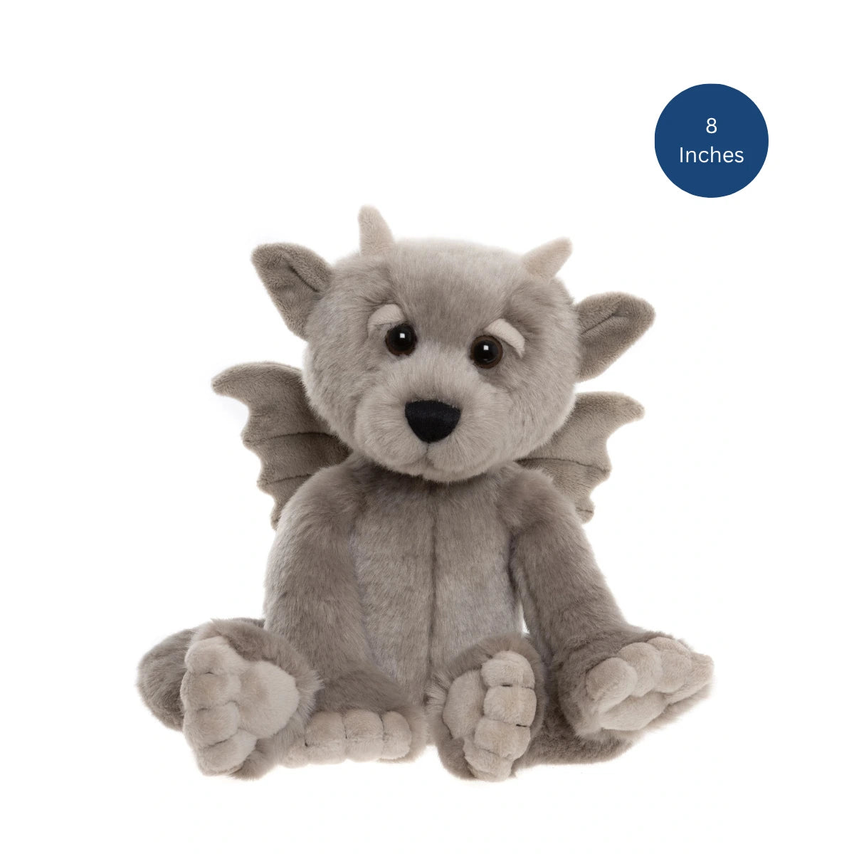 A plush dragon toy in light gray with small wings, large dark eyes, and a black nose, shown sitting on a white background. A blue circular badge in the top right reads '8 Inches'.