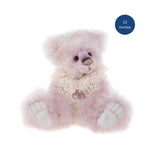 A fluffy pink teddy bear plush toy with white paws and a cream lace collar, shown on a white background with a blue circular badge that reads '13 Inches'.