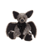 Plush toy bat with a black bow tie on a white background